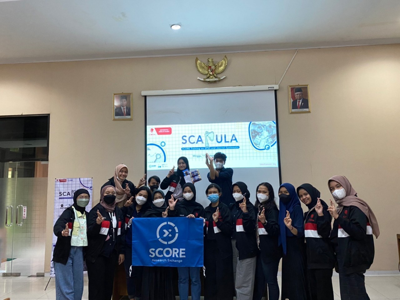 A group of people holding signs

Description automatically generated with medium confidence